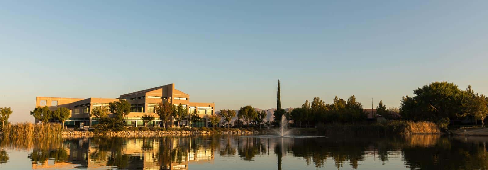 The Lakeside Student Engagement Center at Victor Valley College, seen across the campus lake at golden hour